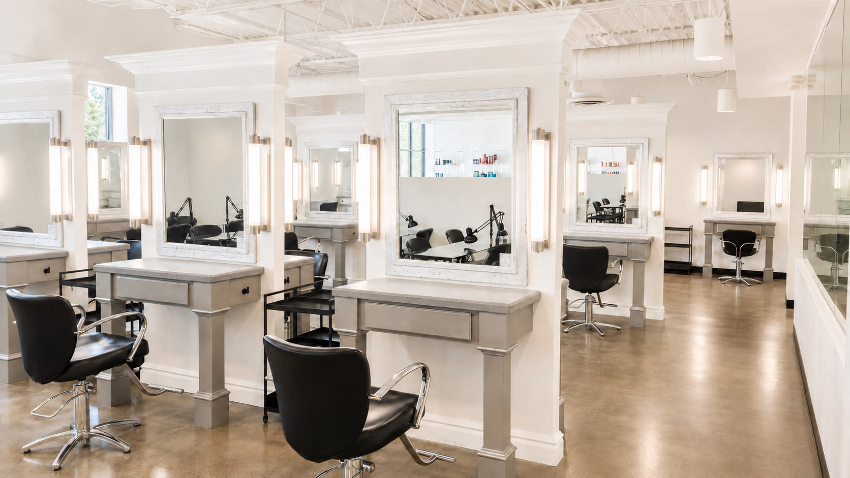 Student salon floor with professional styling stations at Renaissance Academie