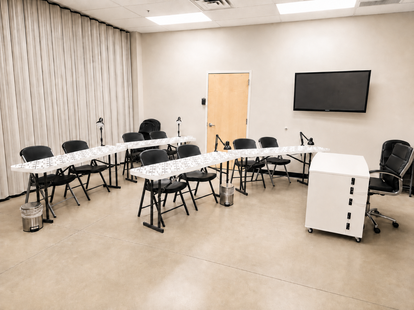 Nail technology classroom with student tables and instructional equipment