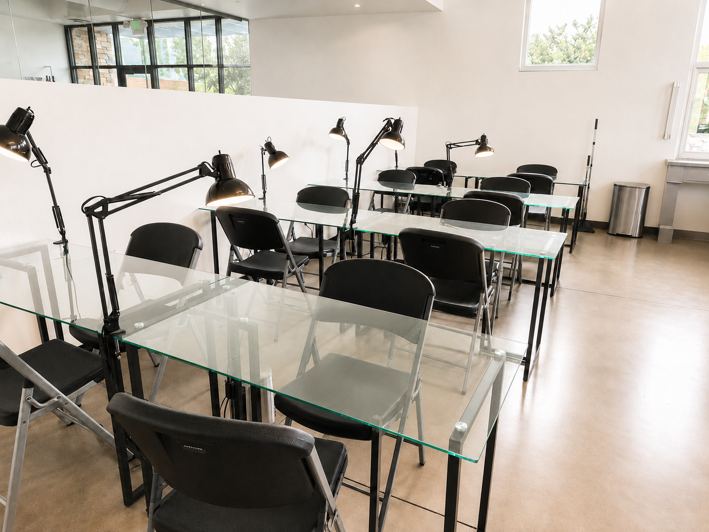 Nail clinic with glass workstations and professional task lighting